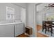 Convenient laundry room with washer, dryer, shelving, and hardwood floors at 803 W Club Blvd, Durham, NC 27701