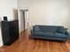 Bright living room featuring hardwood floors, a blue sofa, and a dark dresser at 803 W Club Blvd, Durham, NC 27701