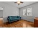 Cozy living room with hardwood floors, neutral walls, and a comfortable blue couch at 803 W Club Blvd, Durham, NC 27701