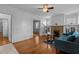 Bright living room featuring hardwood floors, a decorative brick fireplace, and ample natural light at 803 W Club Blvd, Durham, NC 27701