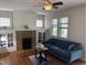 Cozy living room with a brick fireplace, hardwood floors, and natural light at 803 W Club Blvd, Durham, NC 27701
