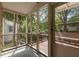Inviting screened-in porch with wooden railings and view of lush backyard trees at 803 W Club Blvd, Durham, NC 27701