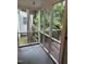 Enclosed porch with white railing provides a cozy outdoor living space at 803 W Club Blvd, Durham, NC 27701