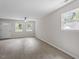Spacious living room features wood-look floors, white trim, and two windows for natural light at 804 Harper Rd, Hillsborough, NC 27278