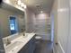 Bright bathroom featuring double sinks, shower and tile flooring at 909 Clearhaven Ln # 909, Fuquay Varina, NC 27526