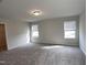 Spacious bedroom featuring carpet, neutral walls, natural light and two windows at 909 Clearhaven Ln # 909, Fuquay Varina, NC 27526
