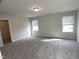 Bright bedroom with neutral walls, cozy carpeting, and abundant natural light from two windows at 909 Clearhaven Ln # 909, Fuquay Varina, NC 27526