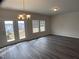 Dining area features a modern chandelier and glass doors leading to the outdoors with natural light at 909 Clearhaven Ln # 909, Fuquay Varina, NC 27526