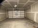 A spacious garage with an overhead door, ready for parking and storage at 909 Clearhaven Ln # 909, Fuquay Varina, NC 27526