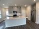 Modern kitchen with a large island, stainless steel appliances, gray cabinets and dark flooring at 909 Clearhaven Ln # 909, Fuquay Varina, NC 27526