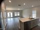 Bright kitchen and living space with gray cabinets, stainless appliances, and open floor plan at 909 Clearhaven Ln # 909, Fuquay Varina, NC 27526