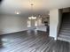 An open layout with dark floors connects the living, dining, and kitchen areas with lots of sunlight at 909 Clearhaven Ln # 909, Fuquay Varina, NC 27526