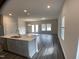 Open-concept living and kitchen area features dark floors, recessed lights, and a kitchen island at 909 Clearhaven Ln # 909, Fuquay Varina, NC 27526