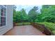 Spacious back deck provides outdoor entertaining with a wood railing and wooded backyard at 99 Grassy Creek Way, Chapel Hill, NC 27517