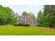 Rear of the home with a large backyard surrounded by mature trees, great for privacy at 99 Grassy Creek Way, Chapel Hill, NC 27517