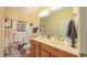 Bright bathroom featuring double sinks, a shower with curtain, and modern fixtures at 99 Grassy Creek Way, Chapel Hill, NC 27517