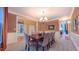 Elegant dining room with a chandelier and seating for eight, with views of the library at 99 Grassy Creek Way, Chapel Hill, NC 27517
