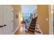 Hallway with hardwood floors and carpeted staircase, connecting the levels of the home at 99 Grassy Creek Way, Chapel Hill, NC 27517