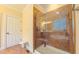 Modern walk-in shower in main bathroom with tiled walls and a built-in bench at 99 Grassy Creek Way, Chapel Hill, NC 27517