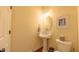 Charming powder room featuring a pedestal sink, decorative mirror, and wood floors at 99 Grassy Creek Way, Chapel Hill, NC 27517