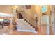 Grand staircase with dark railing, open to the kitchen and entry at 99 Grassy Creek Way, Chapel Hill, NC 27517