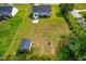 Spacious lot featuring a white home, storage shed, fire pit, and ample green space at 101 Kristina Dr, Selma, NC 27576