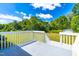 A well-kept deck overlooking the big green lawn and shed at 101 Kristina Dr, Selma, NC 27576