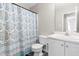 Well-lit bathroom with a patterned shower curtain and a clean white vanity at 101 Kristina Dr, Selma, NC 27576