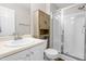 Clean bathroom featuring a glass-enclosed shower and a neutral-toned wooden cabinet at 101 Kristina Dr, Selma, NC 27576