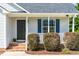 Inviting front porch with brick steps, manicured bushes and a dark front door at 101 Kristina Dr, Selma, NC 27576
