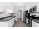 Bright kitchen features modern stainless appliances, ample cabinet space, and gray countertops at 101 Kristina Dr, Selma, NC 27576