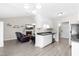 Bright kitchen with white cabinets and black countertops open to the living room at 101 Kristina Dr, Selma, NC 27576