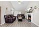 Spacious living room featuring leather furniture, vaulted ceilings, and a cozy fireplace at 101 Kristina Dr, Selma, NC 27576