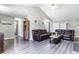 Inviting living room with gray flooring, leather sofas, and easy access to the other rooms in the house at 101 Kristina Dr, Selma, NC 27576