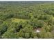Expansive wooded property features an in-ground pool and meticulously maintained grounds at 102 Mel Oak Dr, Chapel Hill, NC 27516