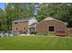Brick home features an in-ground pool, spacious yard, and an outdoor dining area at 102 Mel Oak Dr, Chapel Hill, NC 27516
