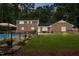 Brick home features a spacious backyard, an in-ground pool, and mature trees at 102 Mel Oak Dr, Chapel Hill, NC 27516