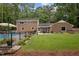 Expansive backyard with inviting pool, lush lawn, and well-maintained landscaping at 102 Mel Oak Dr, Chapel Hill, NC 27516