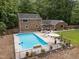 Picture of brick house featuring in-ground pool, patio area, and spacious grassy backyard at 102 Mel Oak Dr, Chapel Hill, NC 27516