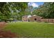 Expansive backyard featuring a well-maintained lawn and an inviting in-ground pool at 102 Mel Oak Dr, Chapel Hill, NC 27516