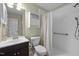 Well-lit bathroom with a shower, cabinet, and mirror at 102 Mel Oak Dr, Chapel Hill, NC 27516