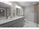 Bathroom with double sinks, marble countertops, and a glass-enclosed shower at 102 Mel Oak Dr, Chapel Hill, NC 27516