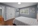 Well-lit bedroom with hardwood floors, a double door closet, and neutral wall paint at 102 Mel Oak Dr, Chapel Hill, NC 27516