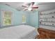 A cozy bedroom includes shelving and two windows offering ample natural light at 102 Mel Oak Dr, Chapel Hill, NC 27516