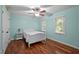 Bright bedroom features hardwood floors, two large windows, and a ceiling fan at 102 Mel Oak Dr, Chapel Hill, NC 27516