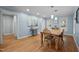 Sunlit dining room with hardwood floors, neutral walls and traditional furnishings with modern lighting at 102 Mel Oak Dr, Chapel Hill, NC 27516