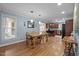 Open-concept dining room featuring hardwood floors and view into kitchen with stainless steel appliances at 102 Mel Oak Dr, Chapel Hill, NC 27516