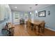 Comfortable dining room with bright light from many windows, hardwood floors and classic chandelier at 102 Mel Oak Dr, Chapel Hill, NC 27516