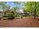 Beautiful brick home with mature landscaping, a cozy sunroom, and lush greenery at 102 Mel Oak Dr, Chapel Hill, NC 27516