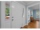 Bright entryway with white door offering natural light, hardwood floors and a security sign at 102 Mel Oak Dr, Chapel Hill, NC 27516
